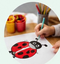 A child drawing a ladybird